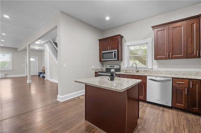 256 Lee St, Hampton, VA 23669 - kitchen with stainless steel appliances, dark wood-style flooring, a kitchen island, light stone counters, and recessed lighting