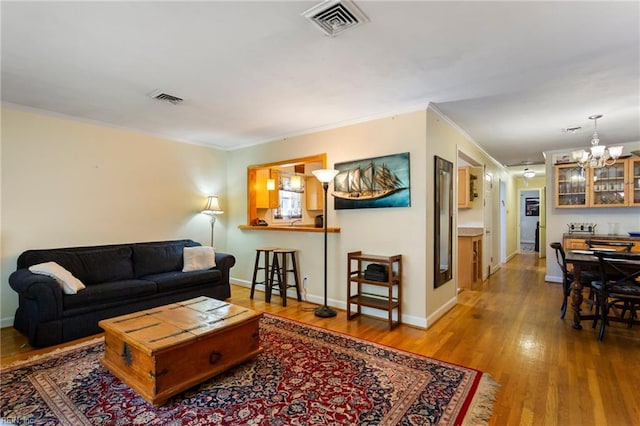 963 Woodrow Ave Unit A, Norfolk, VA 23517 - living area with ornamental molding, a chandelier, and wood finished floors