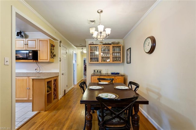 963 Woodrow Ave Unit A, Norfolk, VA 23517 - dining room featuring a chandelier, ornamental molding, and light wood-style flooring