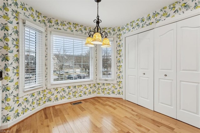 367 Mainsail Dr Unit 23, Hampton, VA 23664 - unfurnished dining area featuring wallpapered walls and light wood-style flooring