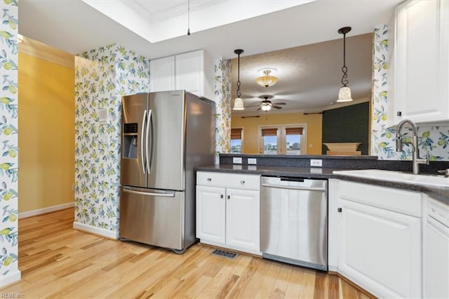 367 Mainsail Dr Unit 23, Hampton, VA 23664 - kitchen with stainless steel appliances, ceiling fan, crown molding, light wood finished floors, and dark countertops