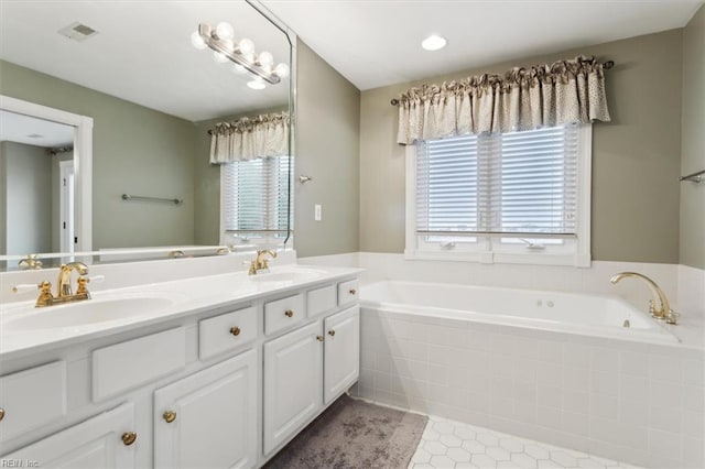 367 Mainsail Dr Unit 23, Hampton, VA 23664 - bathroom with healthy amount of natural light, double vanity, a garden tub, and tile patterned flooring