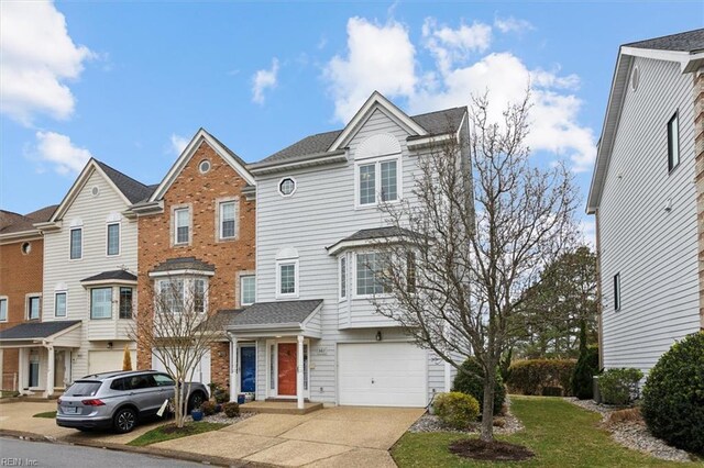 367 Mainsail Dr Unit 23, Hampton, VA 23664 - view of front of property with a garage, concrete driveway, brick siding, and a residential view