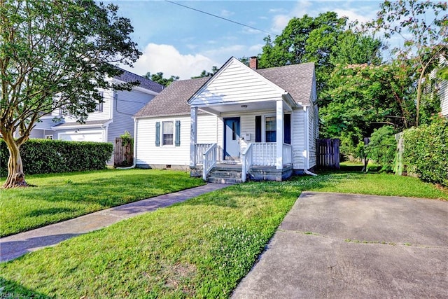 387 Sampson Ave, Hampton, VA 23661 - bungalow-style home featuring covered porch, a chimney, a front lawn, and a shingled roof