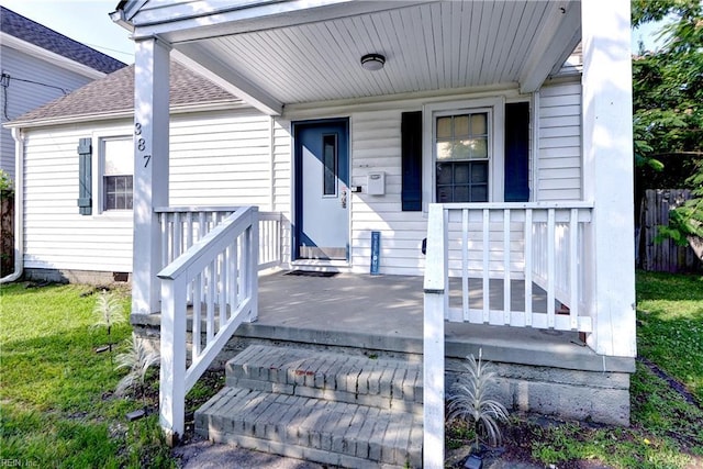 387 Sampson Ave, Hampton, VA 23661 - property entrance with a shingled roof, covered porch, and a yard
