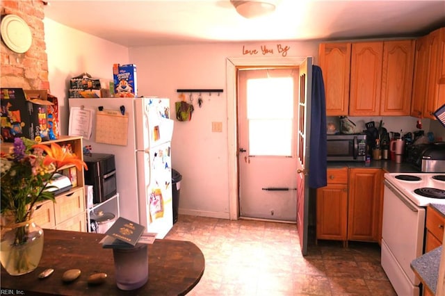 806 Lee St, West Point, VA 23181 - kitchen featuring white appliances, dark countertops, and brown cabinetry
