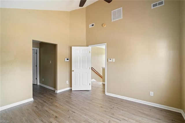 1118 35th St, Newport News, VA 23607 - empty room featuring ceiling fan, high vaulted ceiling, and wood finished floors