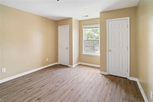 1118 35th St, Newport News, VA 23607 - unfurnished bedroom featuring wood finished floors and baseboards