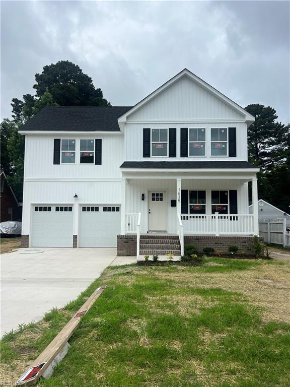 1635 E Bayview Blvd, Norfolk, VA 23503 - view of front of home featuring a garage, a porch, concrete driveway, a front yard, and board and batten siding