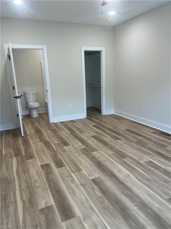 1635 E Bayview Blvd, Norfolk, VA 23503 - unfurnished bedroom featuring wood finished floors, ensuite bath, a spacious closet, and a closet