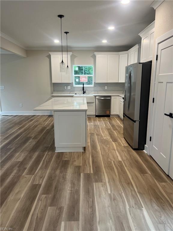1635 E Bayview Blvd, Norfolk, VA 23503 - kitchen with stainless steel appliances, light countertops, recessed lighting, white cabinets, and hanging light fixtures