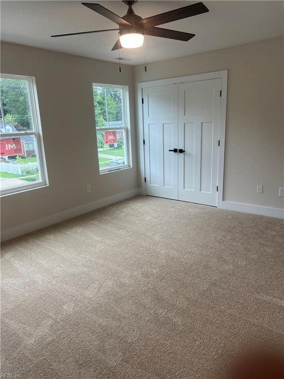 1635 E Bayview Blvd, Norfolk, VA 23503 - unfurnished bedroom with light colored carpet, a closet, and a ceiling fan