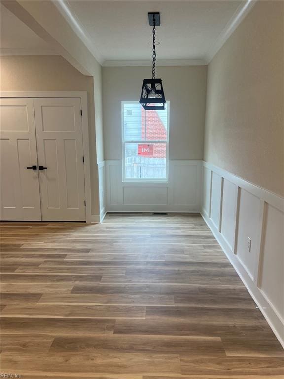 1635 E Bayview Blvd, Norfolk, VA 23503 - unfurnished dining area with crown molding, wood finished floors, a wainscoted wall, and a decorative wall