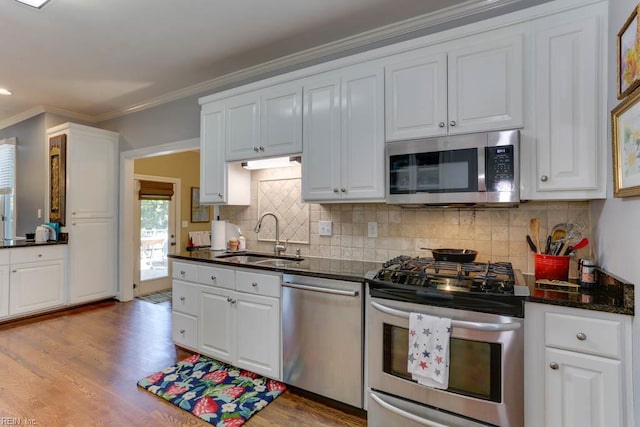 1208 Smith Cove Cir, Virginia Beach, VA 23455 - kitchen featuring appliances with stainless steel finishes, white cabinets, crown molding, and wood finished floors