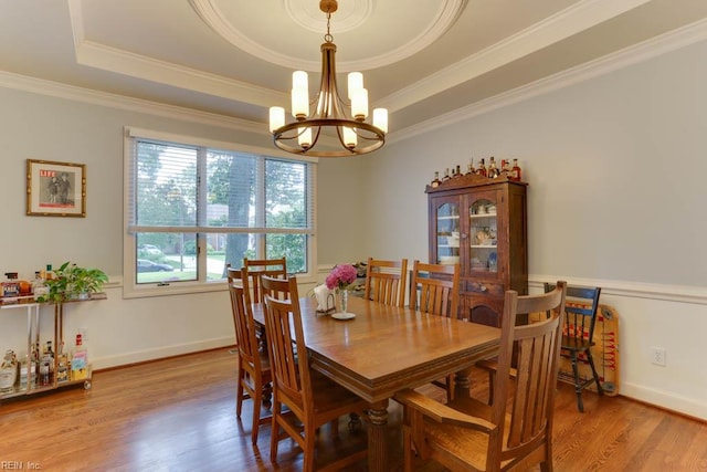 1208 Smith Cove Cir, Virginia Beach, VA 23455 - dining space featuring a chandelier, a tray ceiling, wood finished floors, and ornamental molding