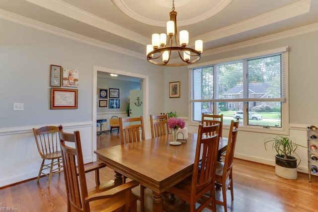 1208 Smith Cove Cir, Virginia Beach, VA 23455 - dining area featuring a tray ceiling, a chandelier, wood finished floors, and ornamental molding