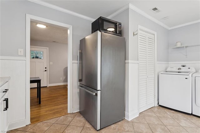 27 Aspenwood Dr, Hampton, VA 23666 - kitchen with freestanding refrigerator, washer / dryer, light tile patterned flooring, crown molding, and a wainscoted wall