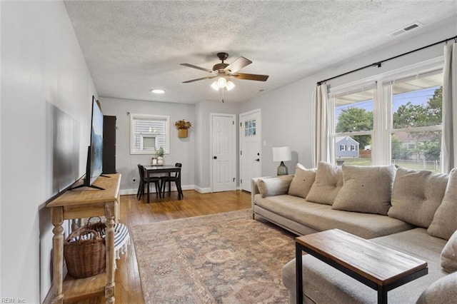 27 Aspenwood Dr, Hampton, VA 23666 - living area featuring wood finished floors, a ceiling fan, a textured ceiling, and healthy amount of natural light