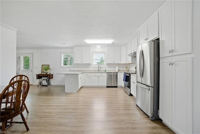 734 Gallbush Rd, Chesapeake, VA 23322 - kitchen featuring appliances with stainless steel finishes, light wood-style flooring, light countertops, white cabinets, and under cabinet range hood