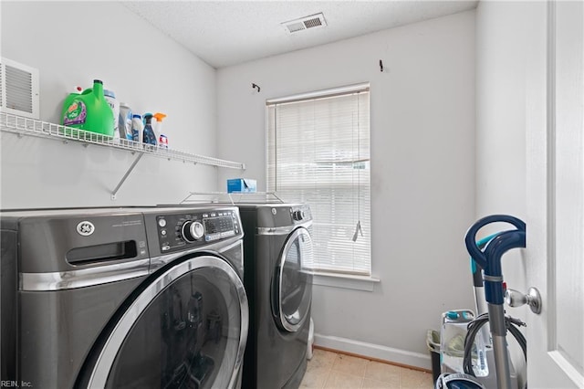 1508 Big Bethel Rd, Hampton, VA 23666 - laundry room featuring washing machine and clothes dryer, light tile patterned floors, and a textured ceiling