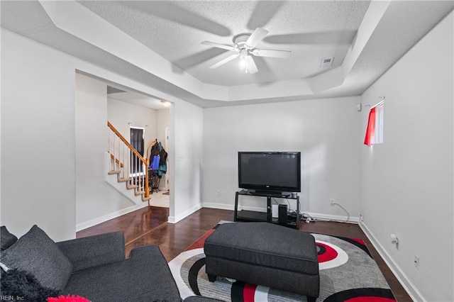 1508 Big Bethel Rd, Hampton, VA 23666 - living area featuring stairs, a tray ceiling, a ceiling fan, a textured ceiling, and wood finished floors