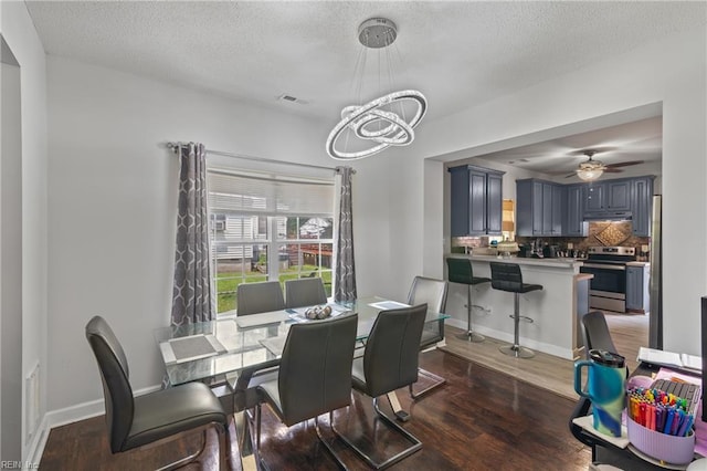 1508 Big Bethel Rd, Hampton, VA 23666 - dining area with a chandelier, dark wood-type flooring, a textured ceiling, and a ceiling fan