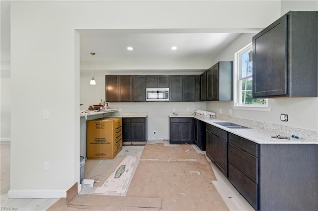 732 Birch Ave, Hampton, VA 23661 - kitchen with stainless steel microwave, light countertops, dark brown cabinets, and recessed lighting