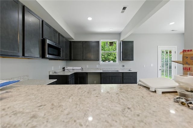 732 Birch Ave, Hampton, VA 23661 - kitchen with stainless steel microwave, light countertops, recessed lighting, and dark cabinetry
