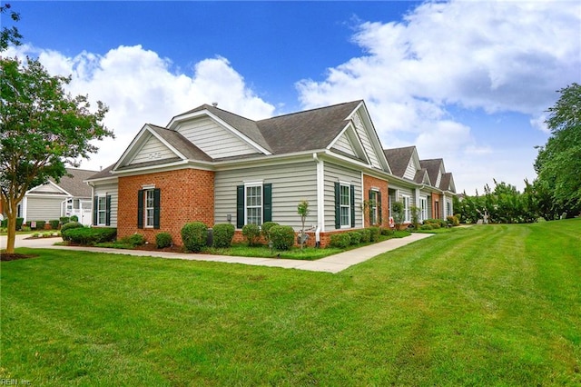 911 Vineyard Pl Unit # C, Suffolk, VA 23435 - view of side of property with brick siding, a lawn, and roof with shingles