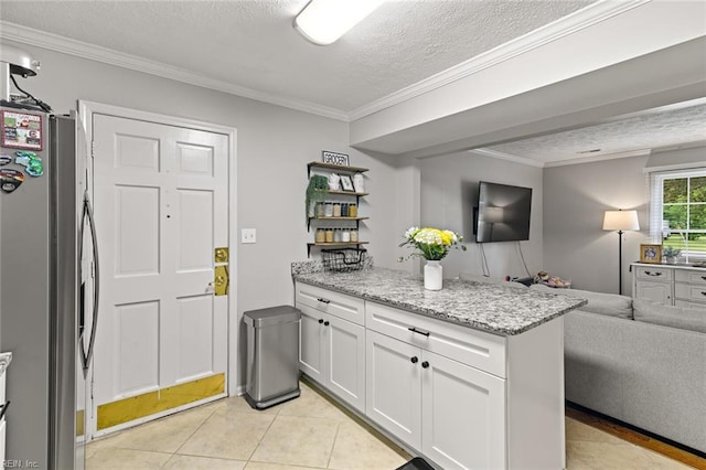 102 Dogwood Dr, Williamsburg, VA 23185 - kitchen featuring freestanding refrigerator, open floor plan, crown molding, white cabinetry, and a textured ceiling