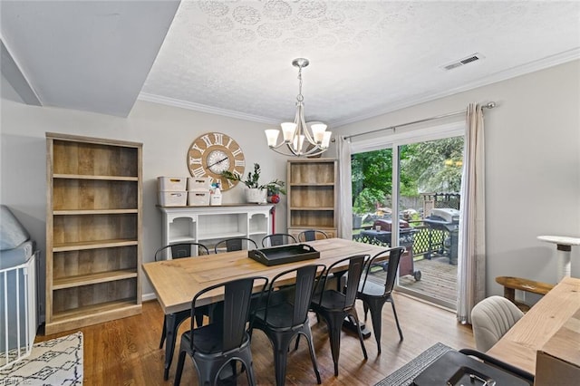 102 Dogwood Dr, Williamsburg, VA 23185 - dining room with a chandelier, wood finished floors, a textured ceiling, and ornamental molding