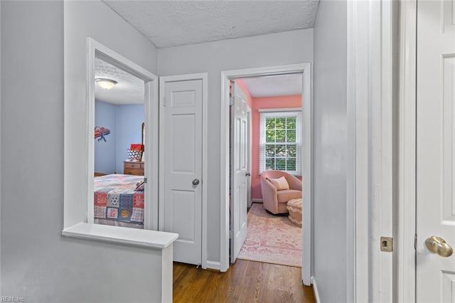 102 Dogwood Dr, Williamsburg, VA 23185 - corridor with dark wood-type flooring and a textured ceiling