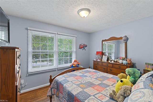102 Dogwood Dr, Williamsburg, VA 23185 - bedroom with wood finished floors and a textured ceiling