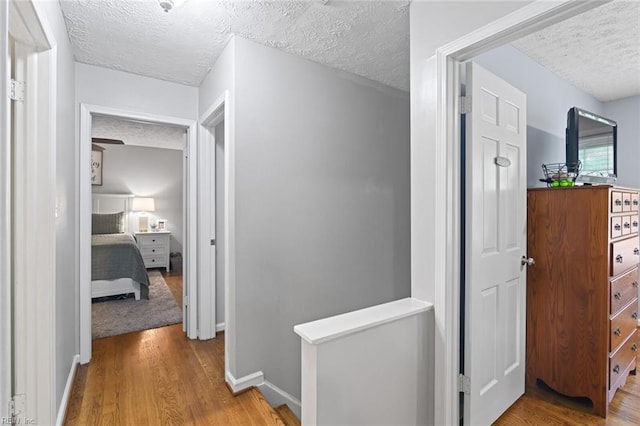 102 Dogwood Dr, Williamsburg, VA 23185 - corridor with a textured ceiling, wood finished floors, and an upstairs landing
