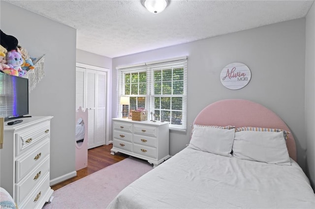 102 Dogwood Dr, Williamsburg, VA 23185 - bedroom with wood finished floors, a closet, and a textured ceiling