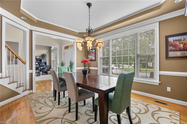 2224 Cabot Ct, Virginia Beach, VA 23456 - dining area featuring crown molding, a chandelier, a tray ceiling, wood finished floors, and stairway