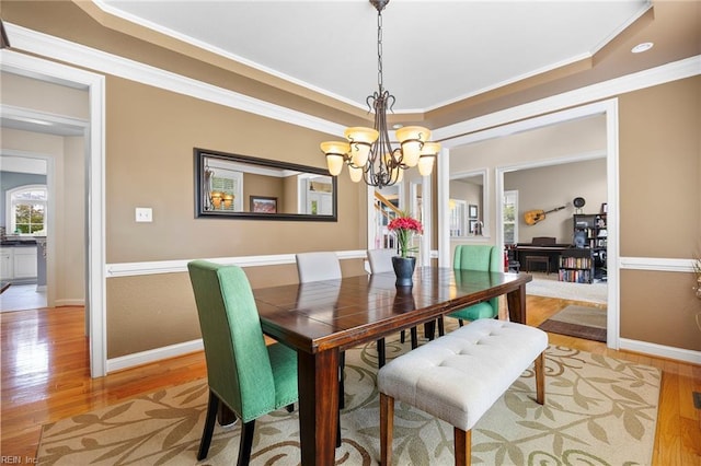 2224 Cabot Ct, Virginia Beach, VA 23456 - dining space with a chandelier, a raised ceiling, light wood finished floors, and ornamental molding