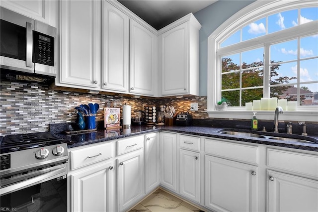 2224 Cabot Ct, Virginia Beach, VA 23456 - kitchen with appliances with stainless steel finishes, light marble finish flooring, white cabinets, and dark stone counters