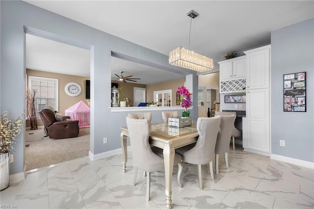 2224 Cabot Ct, Virginia Beach, VA 23456 - dining area with light marble finish floors, a chandelier, and a ceiling fan