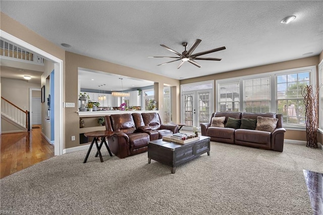 2224 Cabot Ct, Virginia Beach, VA 23456 - carpeted living room with a ceiling fan, a textured ceiling, and stairs