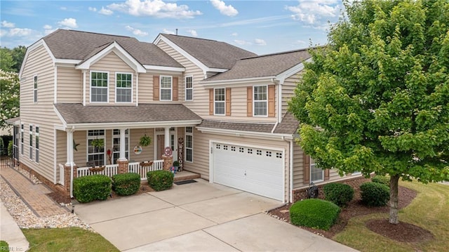2060 Queens Point Dr, Suffolk, VA 23434 - view of front facade with a porch, concrete driveway, a garage, and roof with shingles