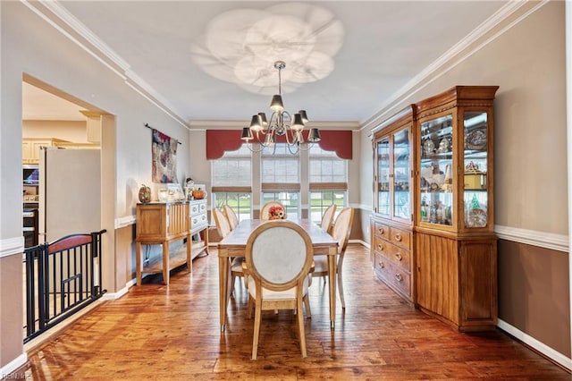 2060 Queens Point Dr, Suffolk, VA 23434 - dining room with a chandelier, wood finished floors, and crown molding
