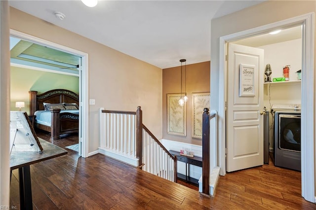 2060 Queens Point Dr, Suffolk, VA 23434 - hall with washer / dryer, an upstairs landing, and dark wood finished floors
