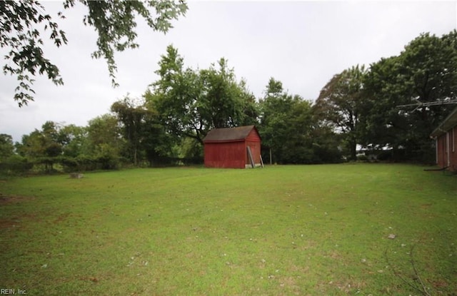 6190 W Blackwater Rd, Zuni, VA 23898 - view of green lawn with a storage unit