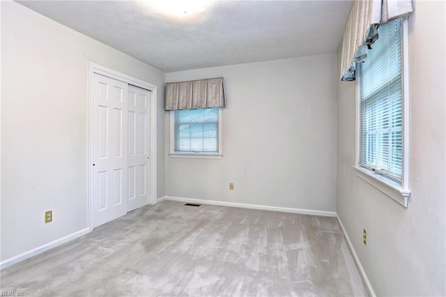 5 Yulee Ct, Hampton, VA 23669 - unfurnished bedroom featuring multiple windows, carpet, and a closet