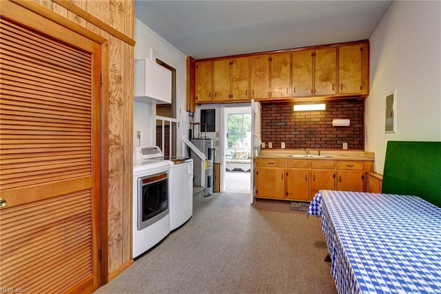 5 Yulee Ct, Hampton, VA 23669 - kitchen featuring washing machine and clothes dryer, electric water heater, light countertops, carpet flooring, and brown cabinets