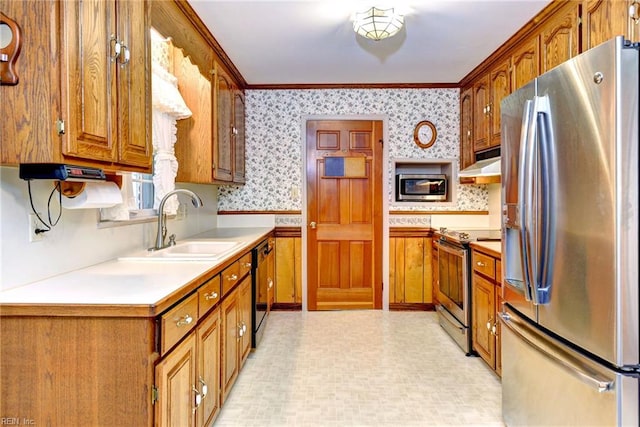 5 Yulee Ct, Hampton, VA 23669 - kitchen with stainless steel appliances, wallpapered walls, under cabinet range hood, brown cabinets, and light countertops