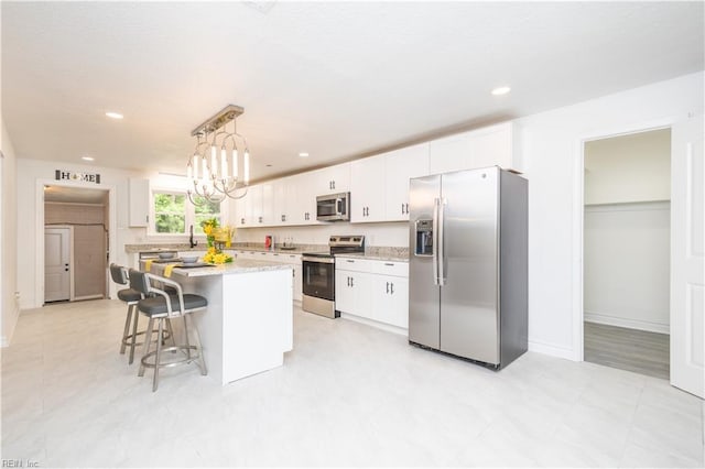 3760 Nansemond Pkwy, Suffolk, VA 23435 - kitchen featuring appliances with stainless steel finishes, white cabinetry, a breakfast bar, a center island, and recessed lighting