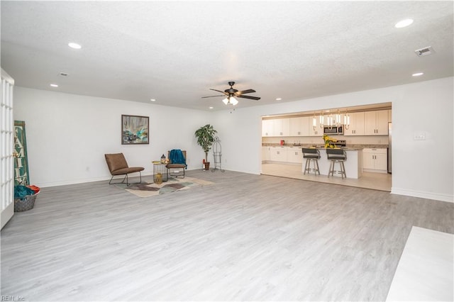 3760 Nansemond Pkwy, Suffolk, VA 23435 - sitting room with recessed lighting, light wood-style floors, ceiling fan, a textured ceiling, and a chandelier