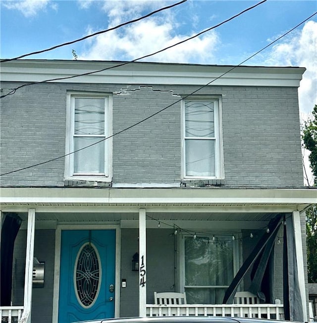 154 Tynes St, Suffolk, VA 23434 - view of front facade featuring brick siding and a porch